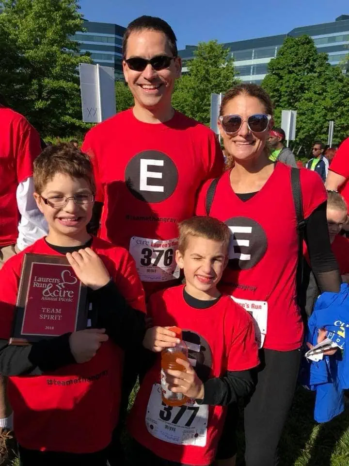 the Ethan Lassiter family each wearing a red shirt with a big "E" on the front