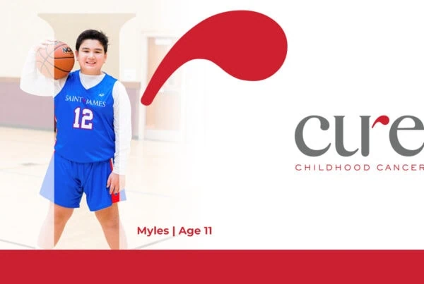 young boy named Myles in a gym holding a basketball, a happy recipient of personalized cancer medicine