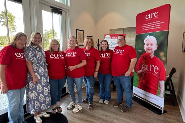 Support group cheering for childhood cancer awareness and research efforts.