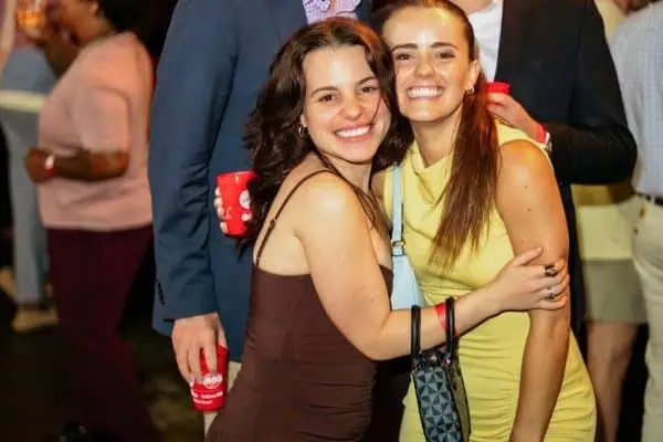 Group of smiling young adults at CURE Childhood Cancer event.