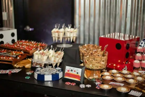 Decorative dessert table for CURE Childhood Cancer event with cupcakes and treats.