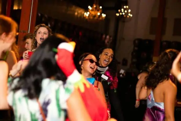 People celebrating at CURE Childhood Cancer event with joyful expressions.