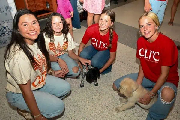 Kids and puppies at CURE Childhood Cancer event in Bryan County.