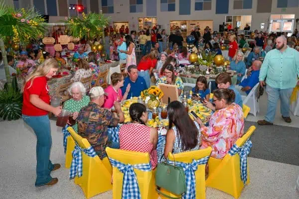 People enjoying a charity event for childhood cancer awareness and support.