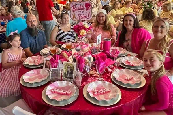 Group of people at a charity event for childhood cancer awareness.