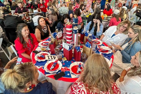 Group of women at a charity event for childhood cancer awareness.