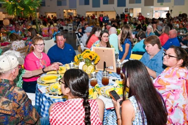People enjoying a community gathering for childhood cancer awareness.