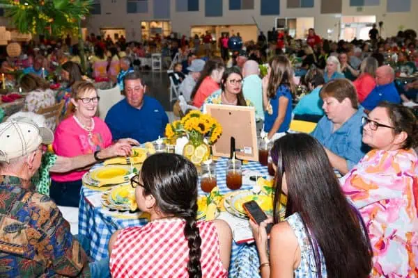 People enjoying a community gathering for childhood cancer awareness.