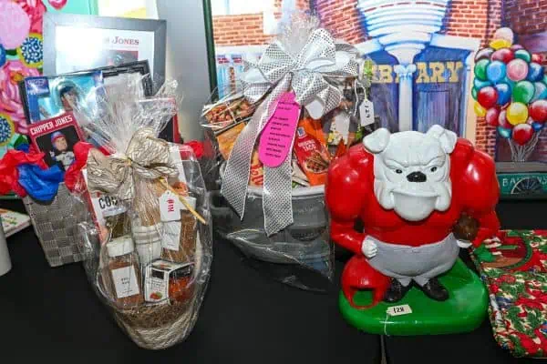 Gift display with toys and a Santa-themed bulldog figurine for CURE Childhood Cancer.