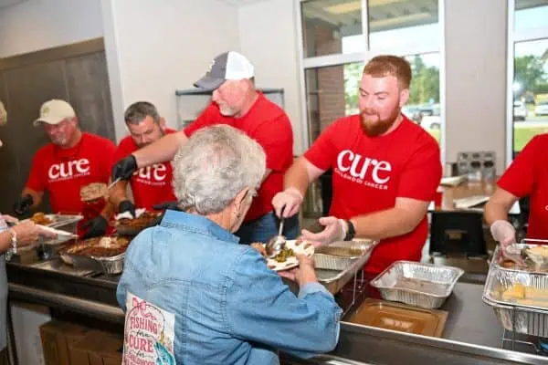 Volunteers serving food at CURE Childhood Cancer event in Bryan County.