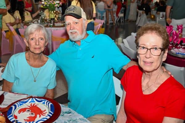 Three people at Catie's Gathering Bryan County event, smiling and enjoying the celebration.