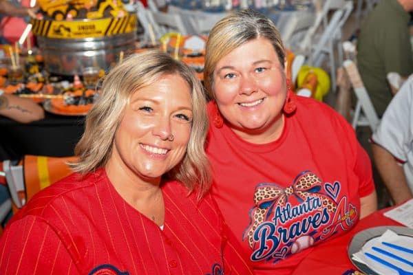 Two women smiling at CURE Childhood Cancer gathering in Atlanta.