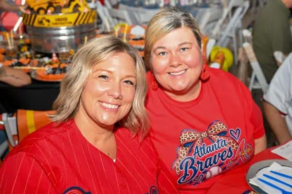 Two women smiling at CURE Childhood Cancer gathering in Atlanta.