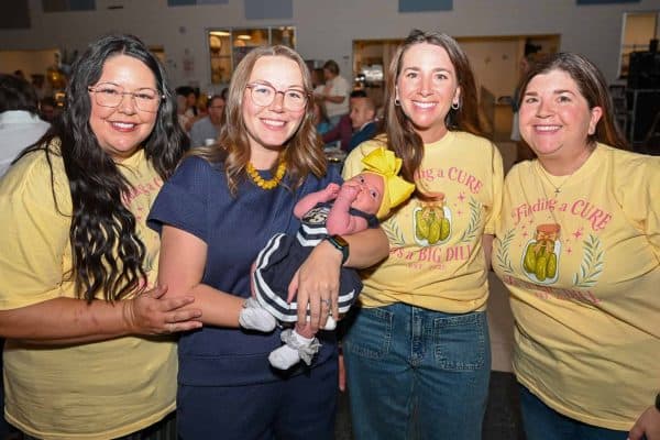 Group of women at CURE Childhood Cancer event smiling for photo.