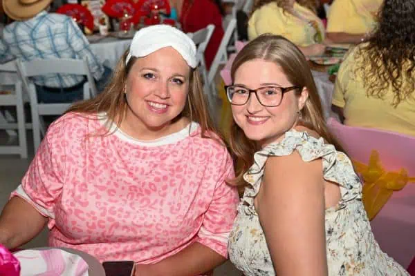 Two smiling women at CURE Childhood Cancer gathering in Bryan County.