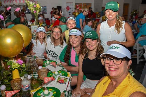 Group of smiling women and girls at CURE Childhood Cancer gathering.
