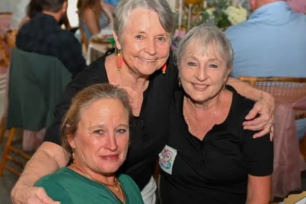 Group of women smiling at CURE Childhood Cancer event.